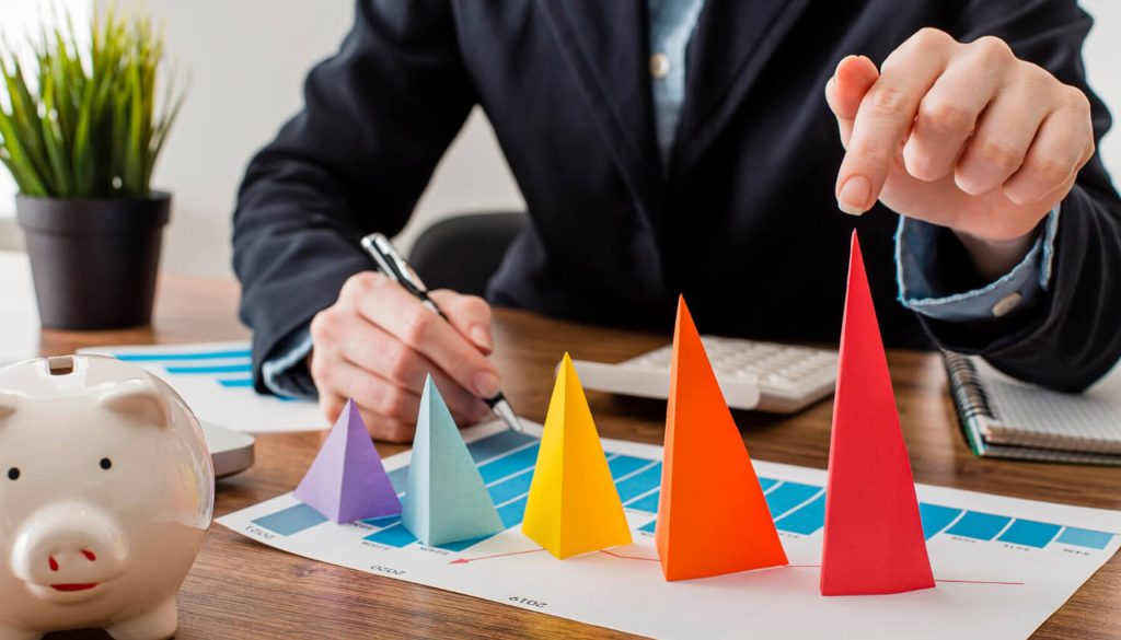 Front view of businessman with colorful cones representing